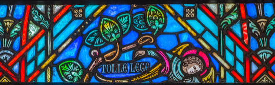 stained glass window with the inscription "tolle lege"